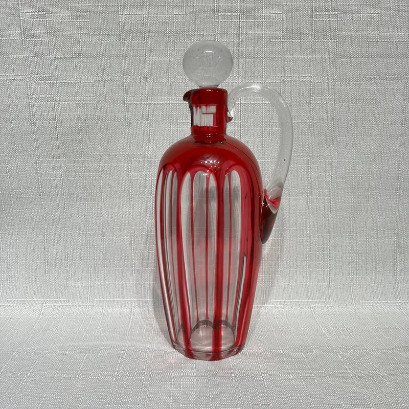 Conjunto de licorera y seis vasitos bordeaux de Cristal Nancy (1921-1934)