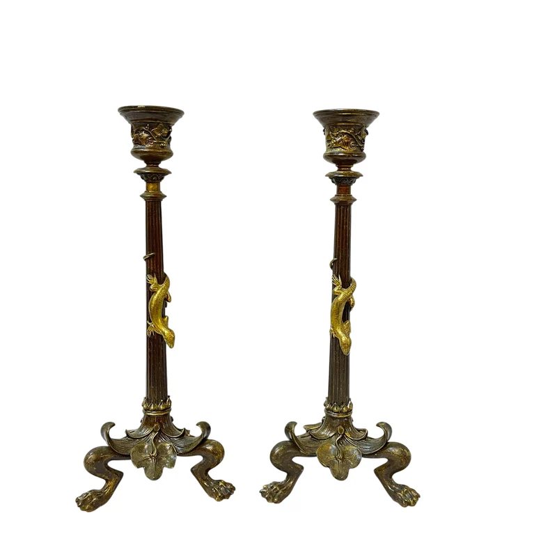 Pair of patinated bronze candlesticks with lion's paws and lizards, late 19th century