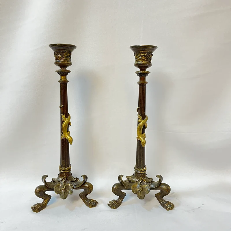 Pair of patinated bronze candlesticks with lion's paws and lizards, late 19th century