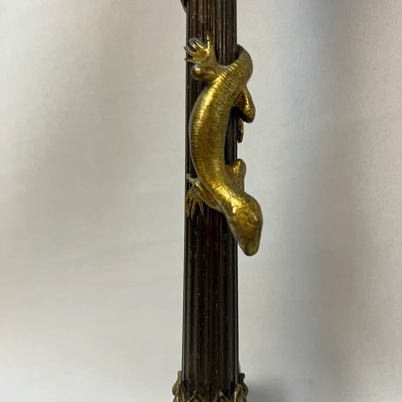 Pair of patinated bronze candlesticks with lion's paws and lizards, late 19th century