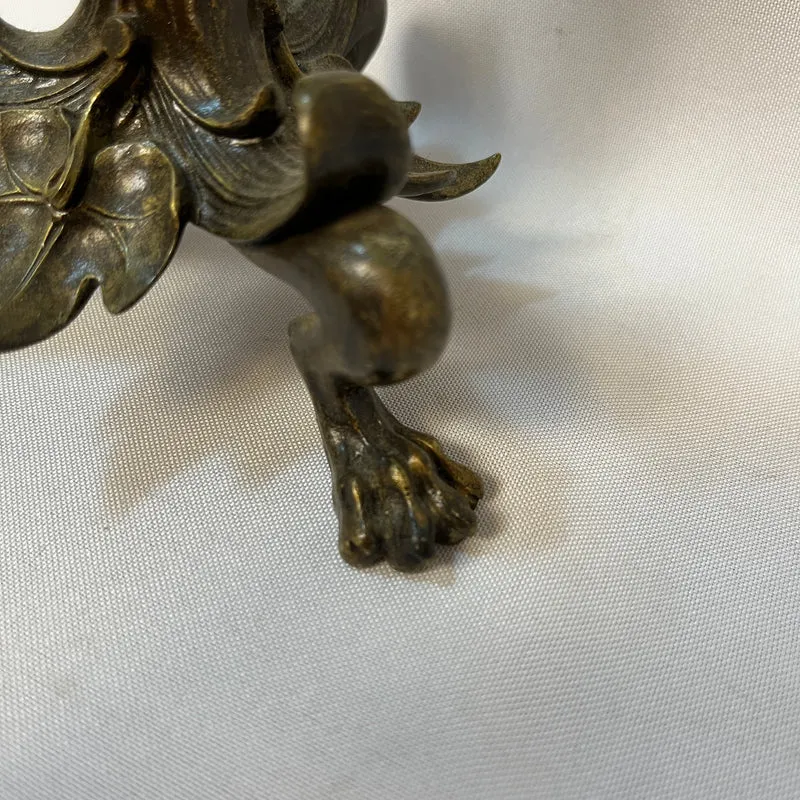 Pair of patinated bronze candlesticks with lion's paws and lizards, late 19th century