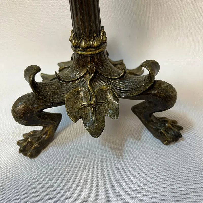 Pair of patinated bronze candlesticks with lion's paws and lizards, late 19th century