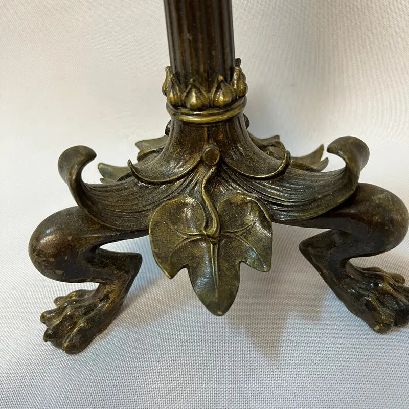 Pair of patinated bronze candlesticks with lion's paws and lizards, late 19th century