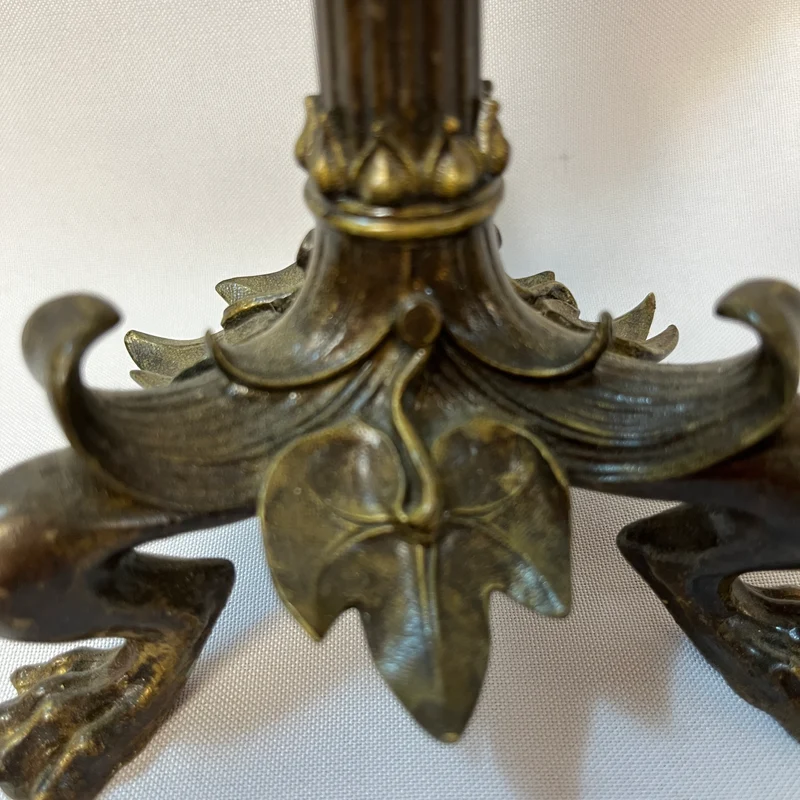 Pair of patinated bronze candlesticks with lion's paws and lizards, late 19th century