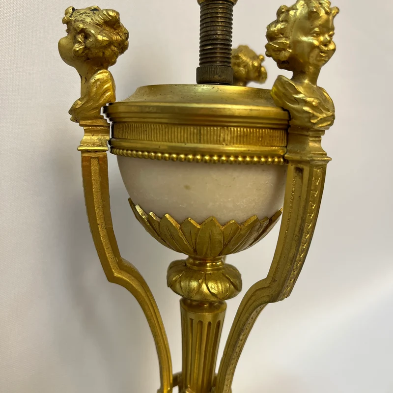 Gilt bronze lamp base and pair of black marble candlesticks, late 19th century