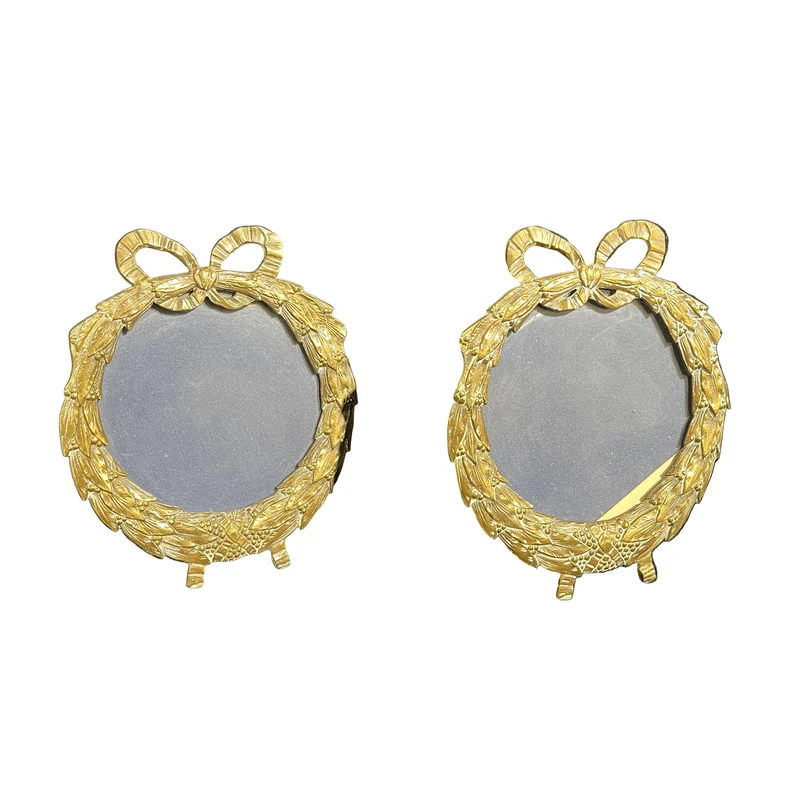 Circular bronze picture frame with garland and belt design