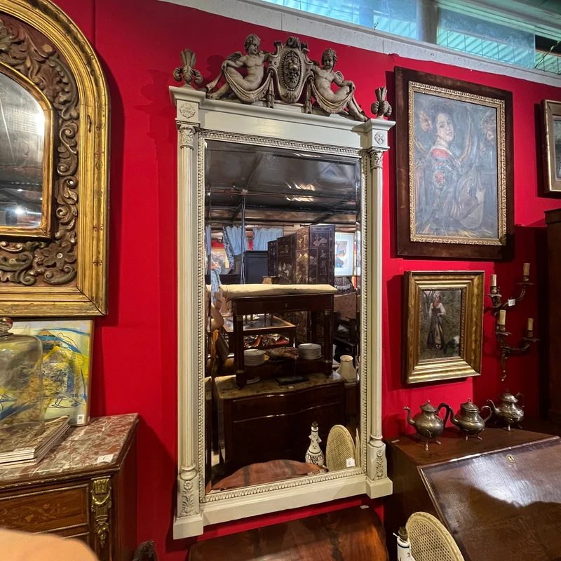 Italian beveled trumeau mirror with carved wood and cupids