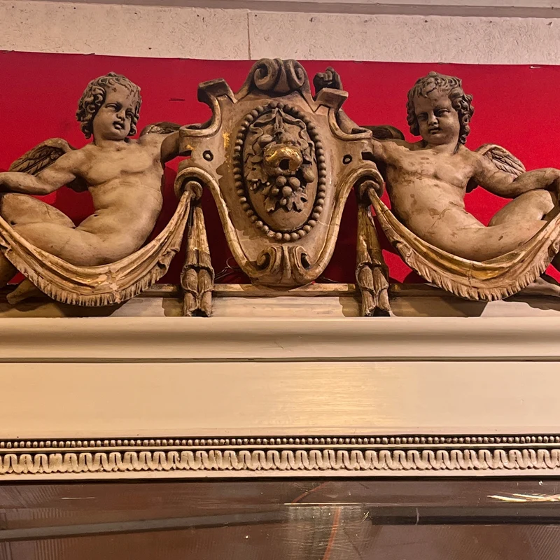 Italian beveled trumeau mirror with carved wood and cupids