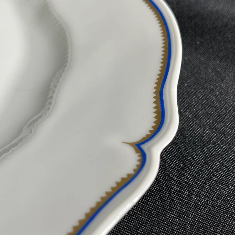 White Limoges Haviland French porcelain with blue rim and gold detail for 12 people
