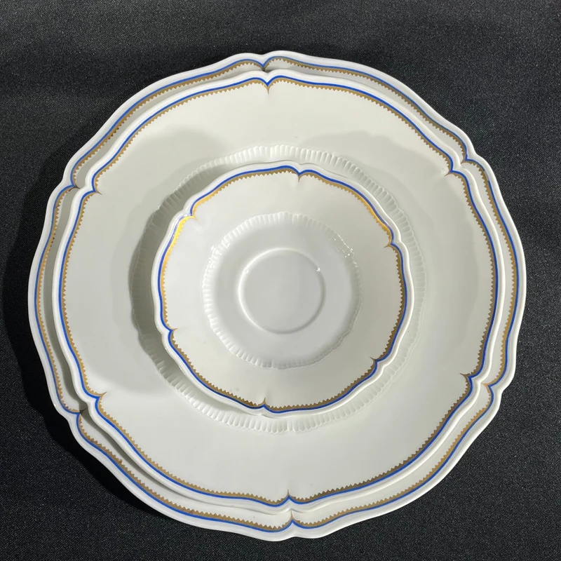 White Limoges Haviland French porcelain with blue rim and gold detail for 12 people