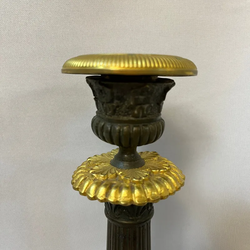 Pair of French tripod candlesticks in patinated and gilded bronze, Restoration style