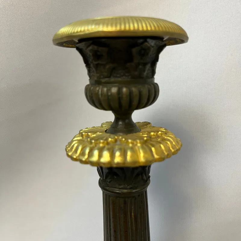 Pair of French tripod candlesticks in patinated and gilded bronze, Restoration style
