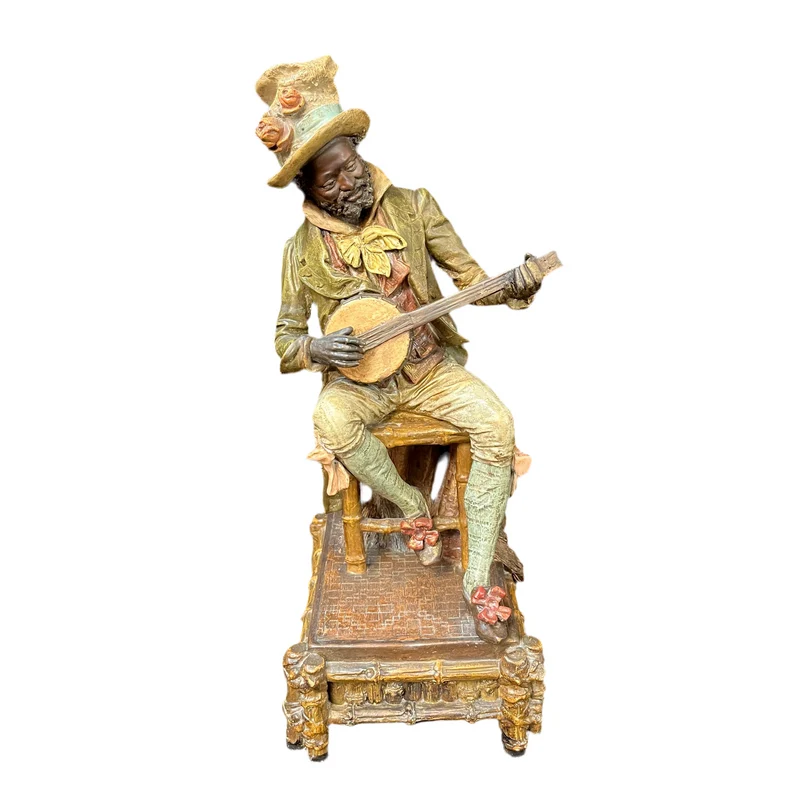 French polychrome terracotta figure of a man playing the banjo