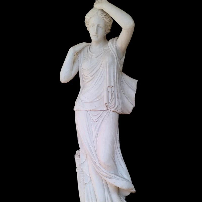 Large marble sculpture of a woman with flowers at her feet