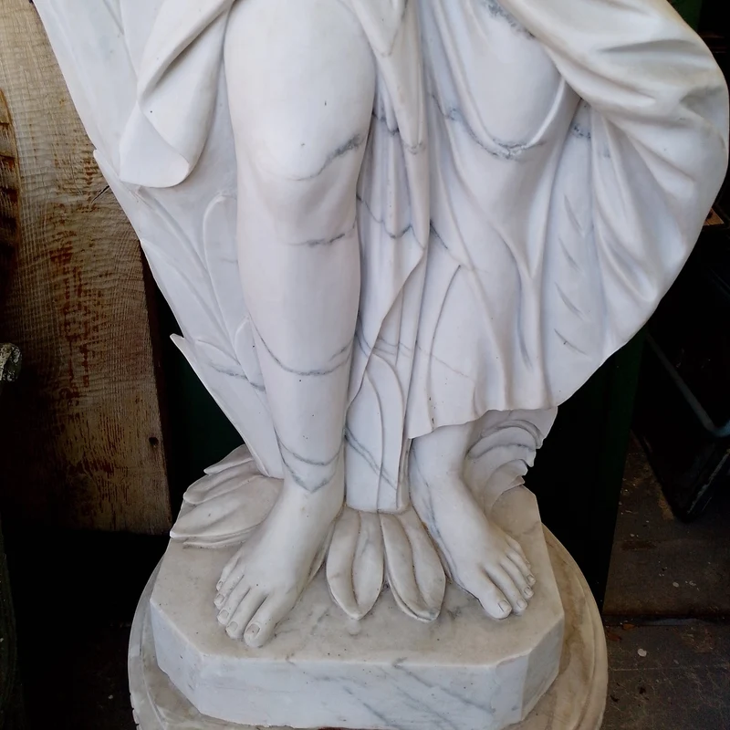 Large marble sculpture of a woman, wheat ears, and flower basket