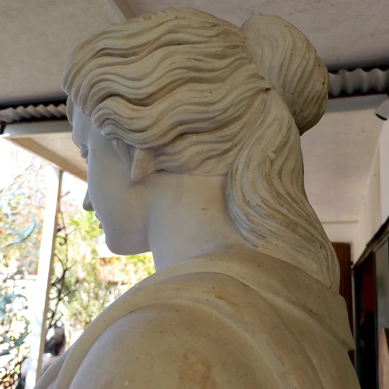 Large marble sculpture of a woman, wheat ears, and flower basket