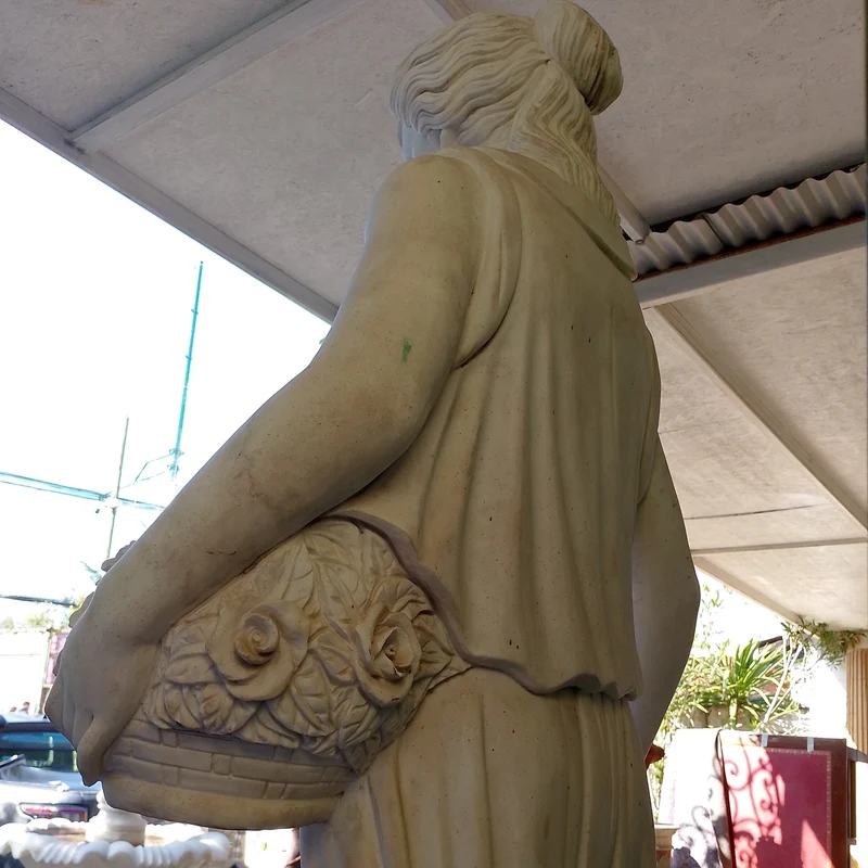 Large marble sculpture of a woman, wheat ears, and flower basket