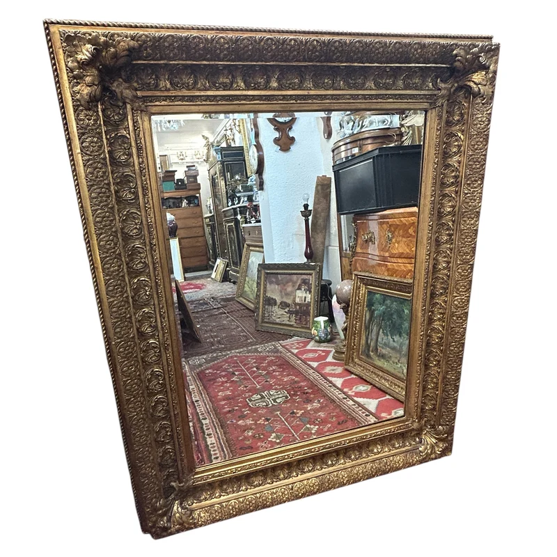 French beveled mirror with carved gilt wood in relief