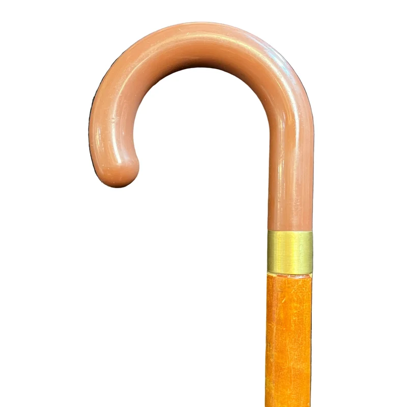 Wooden walking stick with gold ring and curved handle