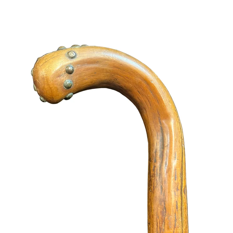 Rustic wooden walking stick with tacks