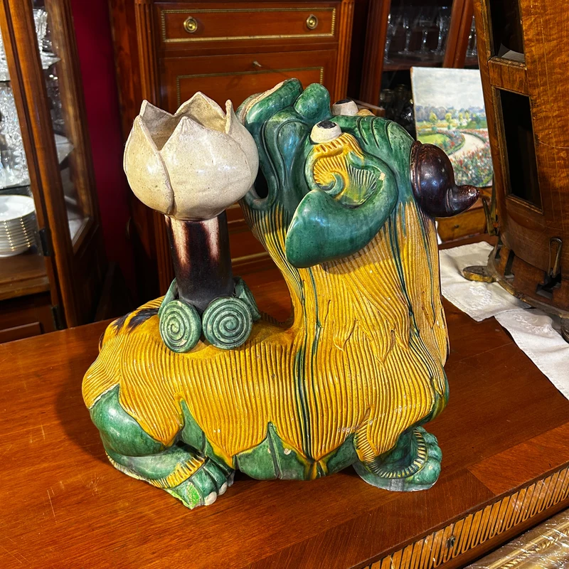 Chinese glazed ceramic figure of a Fo dog with a lotus flower