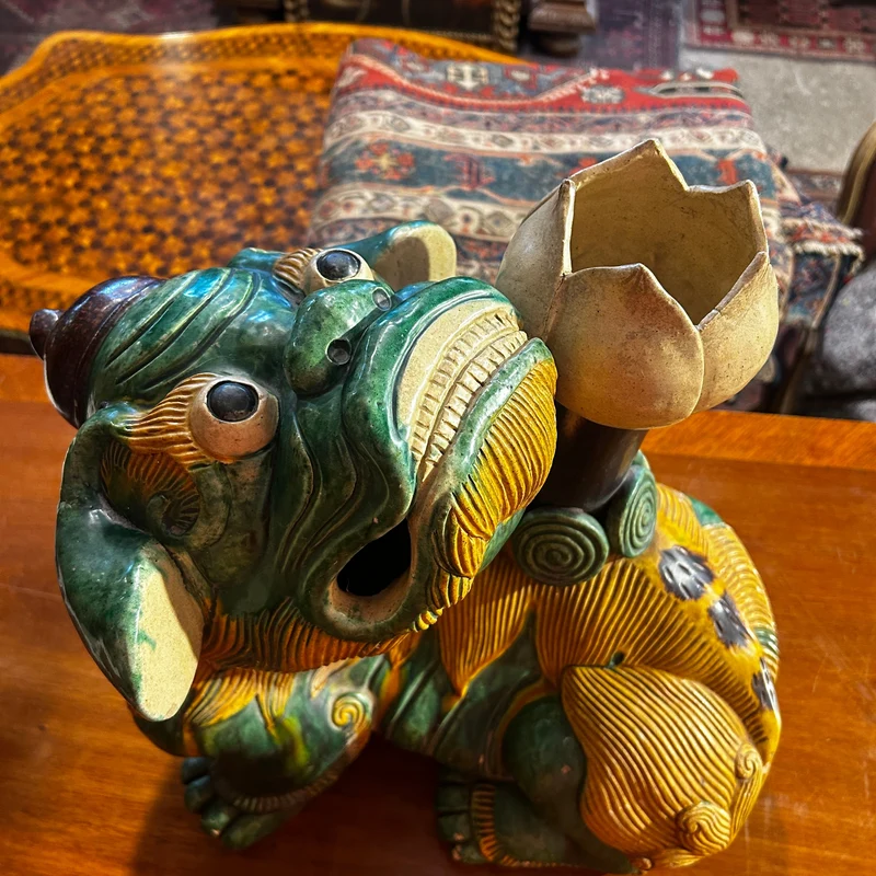 Chinese glazed ceramic figure of a Fo dog with a lotus flower