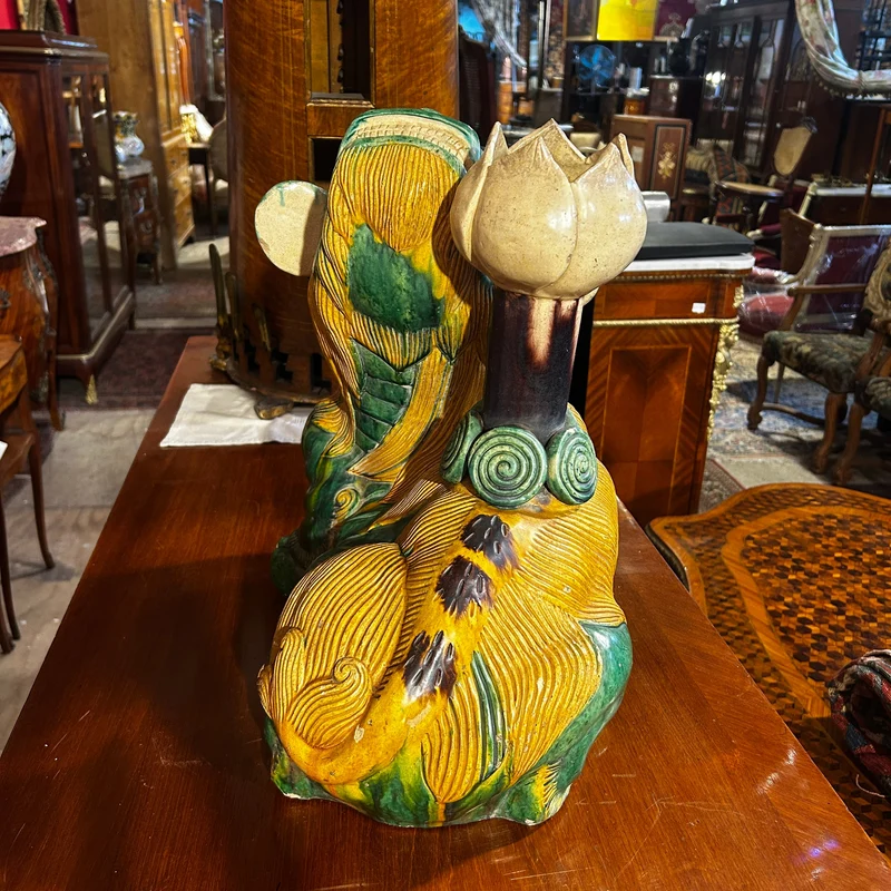 Chinese glazed ceramic figure of a Fo dog with a lotus flower