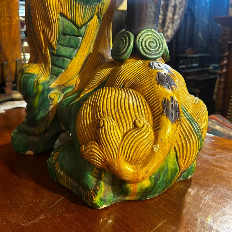 Chinese glazed ceramic figure of a Fo dog with a lotus flower
