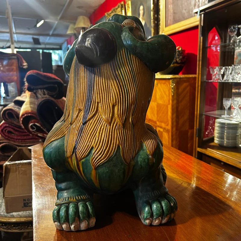 Chinese glazed ceramic figure of a Fo dog with a lotus flower