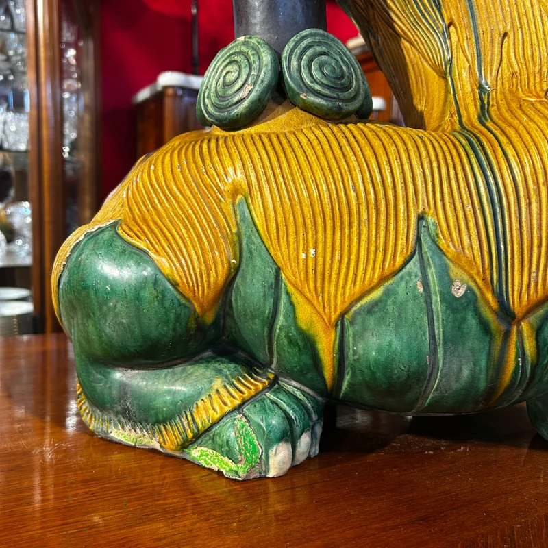 Chinese glazed ceramic figure of a Fo dog with a lotus flower