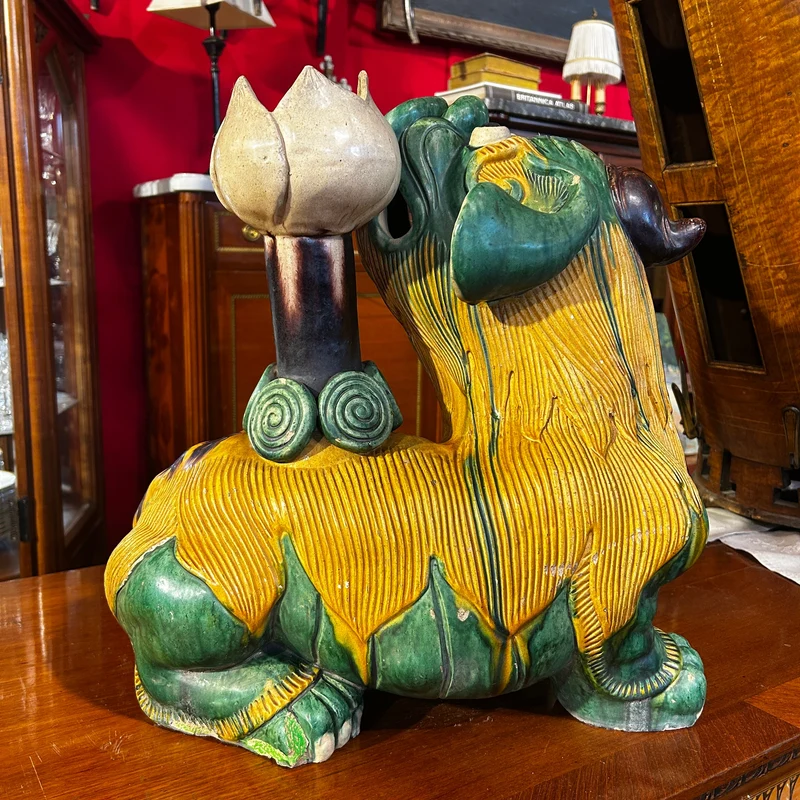 Chinese glazed ceramic figure of a Fo dog with a lotus flower