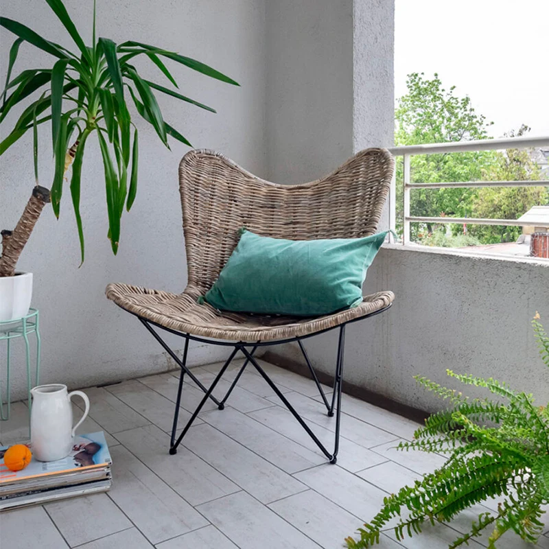 Contemporary Scandinavian Handwoven Rattan Lounge Chair - Accent Chair With Ergonomic Backrest & Iron Base For Boutique Indoor & Outdoor Spaces