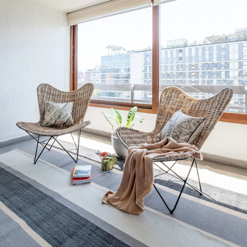 Contemporary Scandinavian Handwoven Rattan Lounge Chair - Accent Chair With Ergonomic Backrest & Iron Base For Boutique Indoor & Outdoor Spaces