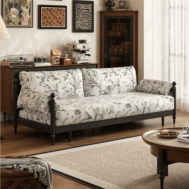 Sofá cama Gland con estructura de madera maciza de fresno y tapizado en tela de terciopelo estampada.