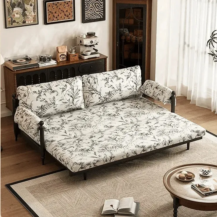 Sofá cama Gland con estructura de madera maciza de fresno y tapizado en tela de terciopelo estampada.