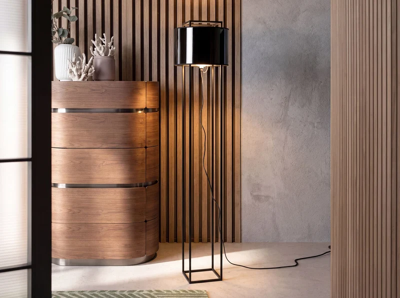 Black steel floor lamp with black PVC shade and gold interior